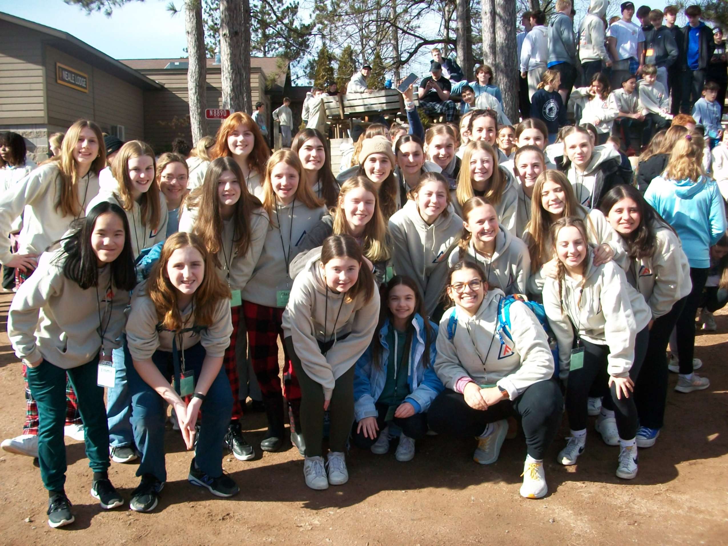 A group of students poses for a photo at a student youth group retreat.